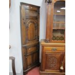 A XX Century Oak Double Corner Cupboard, with arched panel door, base with panelled door, on bracket