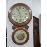 A XIX Century Wall Clock, with a white dial, Roman numerals, over a circular glazed door, with a