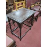 An Early XX Century Oak Side Table, with a carved top, shaped apron, on turned and block supports.