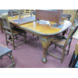 A 1930's Mahogany Wind Out Dining Table, (two extra leaves), top with a moulded edge, on cabriole