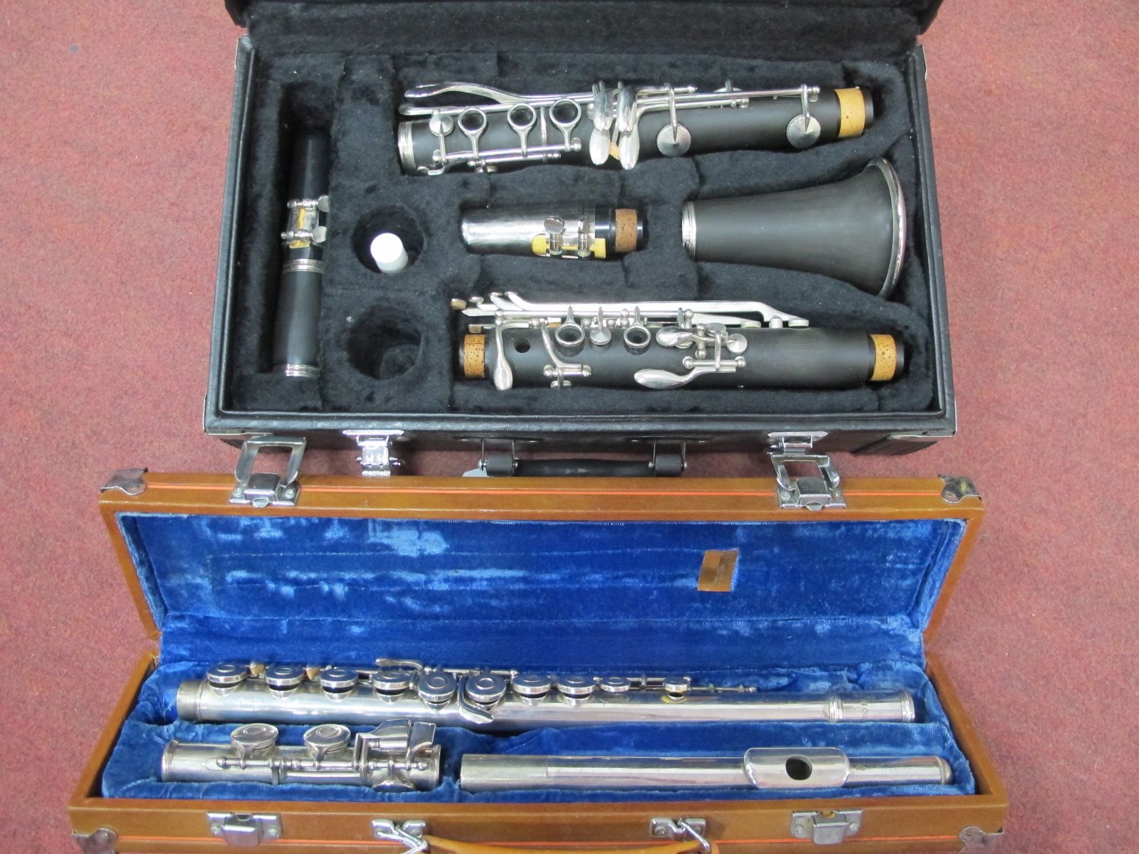 A Clarinet, four sectional, in case, Lark three sectional flute, in case. (2)