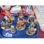 Hummel Figurines, including shoe seller, girl holding basket and envelope, pram. (8)