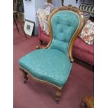 A XIX Century Walnut Spoon Back Salon Chair, with carved cresting re upholstered in a green