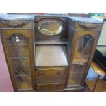 A 1920's Oak Side by side Book Cabinet, with lead glazed doors, flanking fall front over two