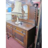 A 1920's Oak Mirror Back Sideboard, with barley twist supports, two drawers over two doors, 122cm