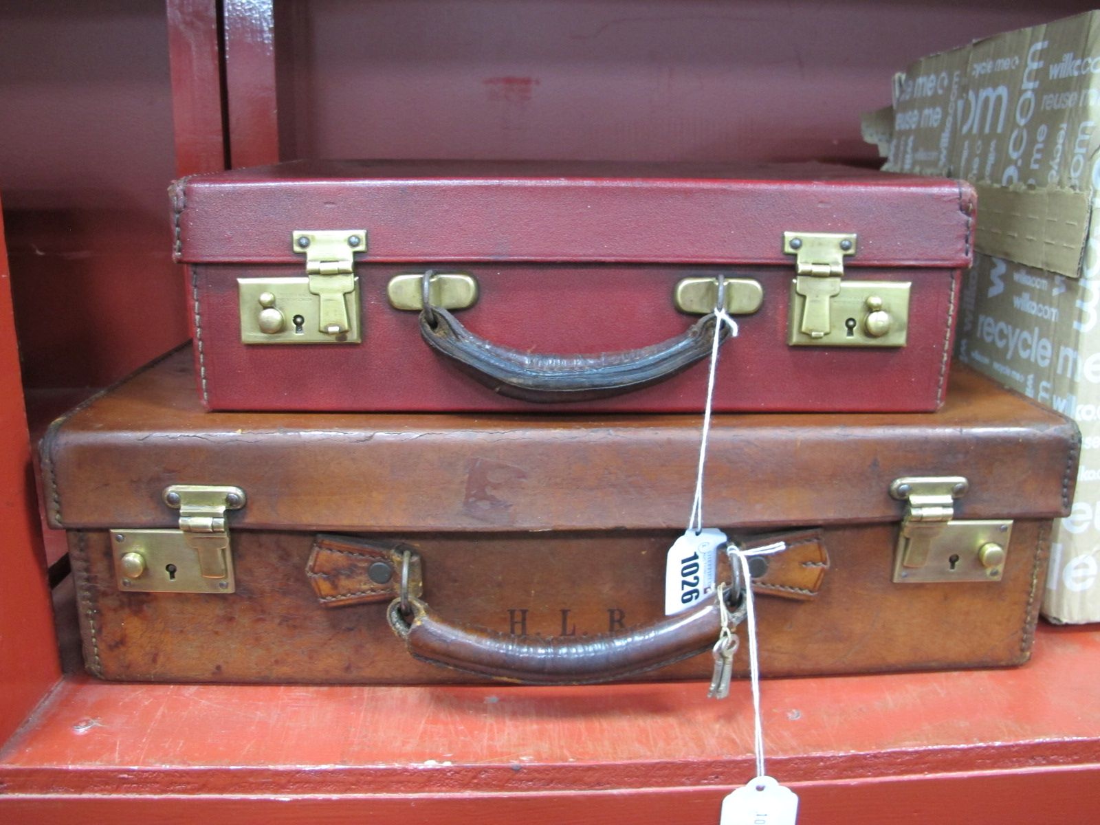 A Small Early XIX Century Leather Suitcase, with brass locks and keys, approximately 45cm wide,