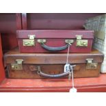 A Small Early XIX Century Leather Suitcase, with brass locks and keys, approximately 45cm wide,