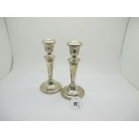 A Pair of Hallmarked Silver Candlesticks, PPLtd, London 1956, of plain tapering form, on spreading