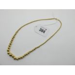 A Graduated Single Strand Bead Necklace, on fine chain, stamped "750". 44.5cm long.