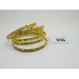 Six High Carat Indian Bangles, with engraved decoration. (6)