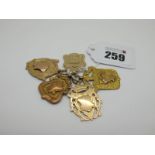 Five 9ct Gold Medallion Pendants, one engraved "Thurcroft A.C. Winner 1948 J Shaw", another "W.&.D.