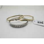 A Modern 9ct White Gold Diamond Set Bangle, of graduated Greek Key design to the front, hinged to