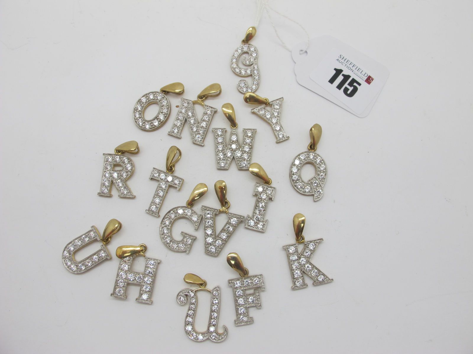 Sixteen Assorted 9ct Gold Initial Pendants, with inset highlights. (16)