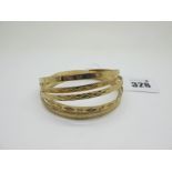 Six 9ct Gold Bangles, each with engraved decoration. (6)