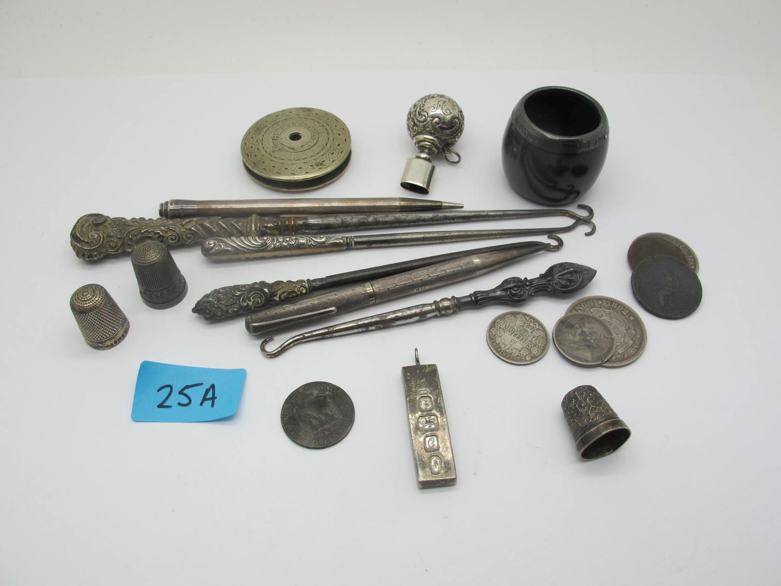 A Hallmarked Silver Ingot Pendant, button hooks, coins, thimbles, engine turned pencils, etc.