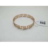 A Greek Key Design Bangle, stamped "S&P 9ct".