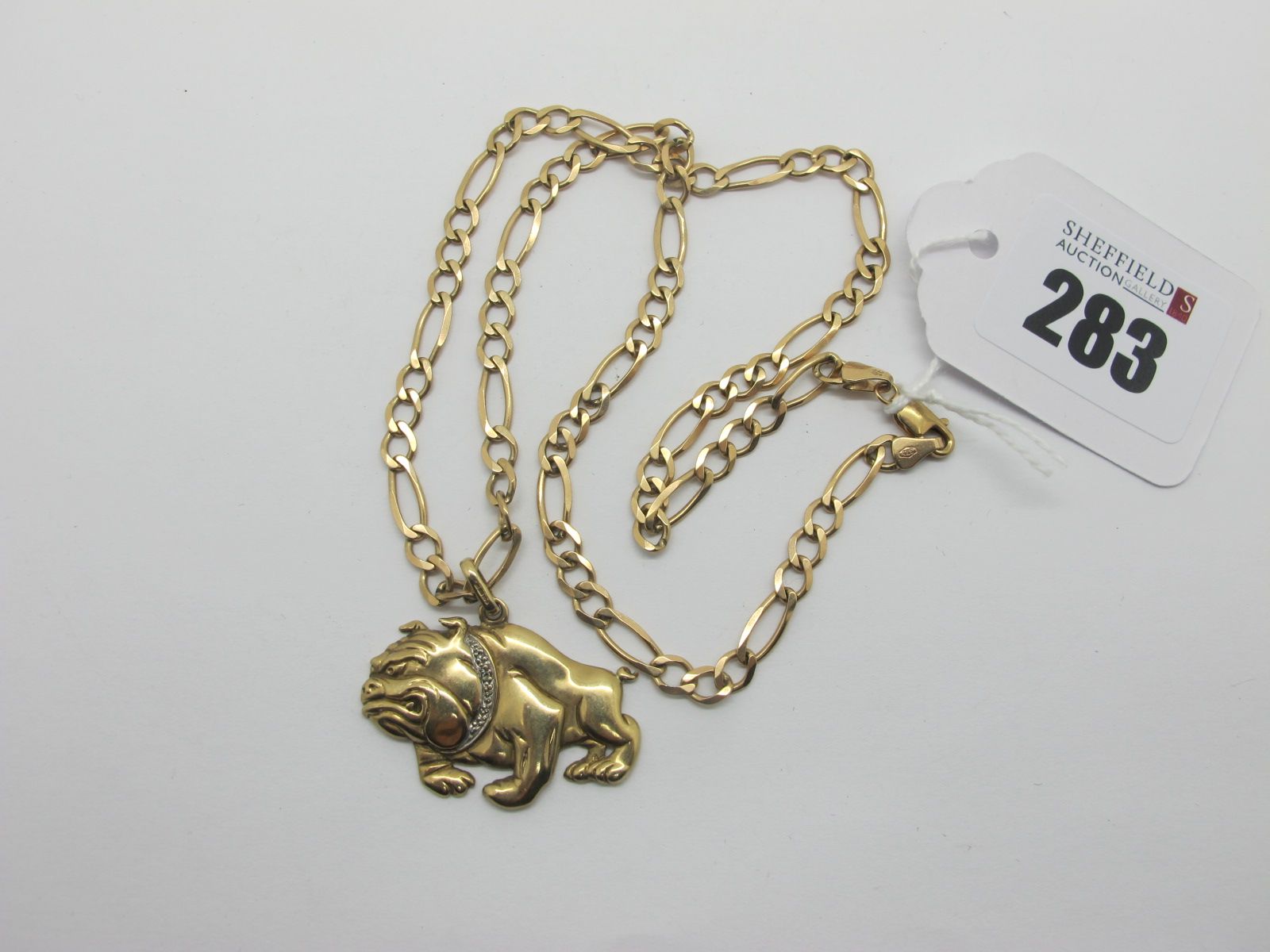 A 9ct Gold Bulldog Pendant, with inset highlights, on a 9ct gold chain.