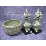 Caladon Pottery, pair of Mythological beasts, probably Vietnamese, on hardwood stand, 33cm high, (