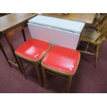 A Vintage Formica Kitchen Table, with drop leaves, together with a pair of kitchen stools, with