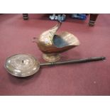 A XIX Century Copper Coal Helmet, with scroll supports and ebonized handle. A XIX Century copper