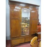 An Edwardian Inlaid Mahogany Wardrobe, with a central mirror door, two short drawers, on bracket