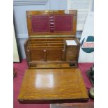 An Early XX Century Oak Stationary Box, with a hinged lid, fitted interior, with a fall front, red