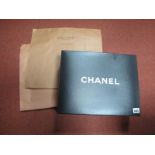A 'Chanel' retailers box, outer carry bag with ribbon ties and two brown paper 'Louis Vuitton'