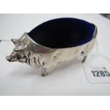 A Pin Cushion, in the form of a pig, in white metal, 11cm long.