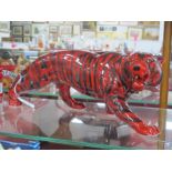 An Anita Harris Model of a Bengal Tiger, in ruby and black, gold signed, 40cm long, 14.5cm high.