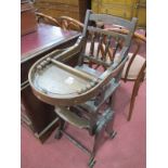 An Early XX Century Walnut Child's Convertible High Chair, with drop down tray and bauble ring,