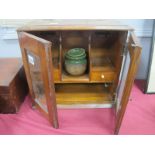 An Early XX Century Oak Smokers Cabinet, with a hinged lid, glazed doors, two small drawers,