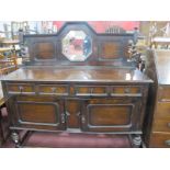 A 1920's Oak Mirror Back Sideboard, the back with an octagonal mirror, turned supports, base with