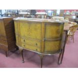 A Walnut Cabinet, with bowed end cupboard doors, fall front over two drawers on cabriole legs,