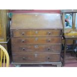 An XVIII Oak Bureau, with a crossbanded fall, fitted interior, four long drawers, on bracket feet,