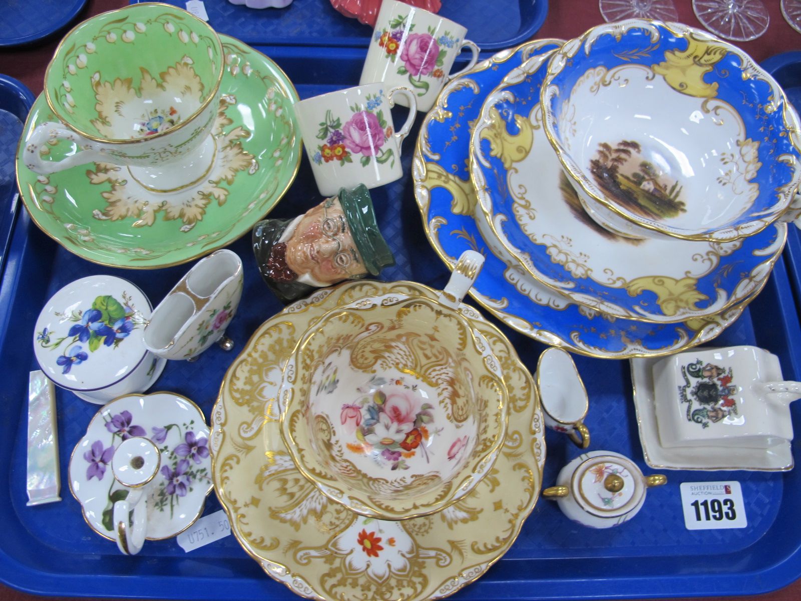 A XIX Century Hand Painted Trio, in the Rockingham manner, two similar cups and saucers,