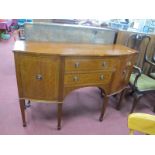 A Mahogany Sideboard for Ponsfords of Sheffield, with carved end cupboard doors, flanking twin