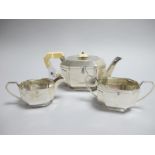 A Hallmarked Silver Three Piece Tea Set, HMS, Sheffield 1939, of Art Deco style, the tea pot with