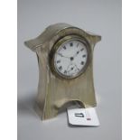 A Hallmarked Silver Mounted Bedside Clock, JGLtd, Birmingham 1916, of shaped design with engine