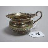 A Hallmarked Silver Jug, Walker & Hall, Sheffield 1902, of compressed circular form, semi reeded,