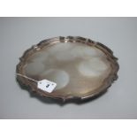 A Hallmarked Silver Salver, SG, Sheffield 1974, of plain shaped circular form, on three scroll feet,