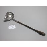 A Hallmarked Silver Toddy Ladle, (marks rubbed) the shaped bowl with side spout, initialled, with