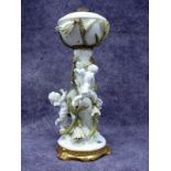 A Late XIX/Early XX Century Moore Bros. Porcelain Oil Lamp, modelled with cherubs climbing up the