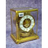 A Jaeger Le Coultre Atmos Clock, in gilt brass glazed case, the white enamel chapter ring with