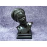 An Early XX Century Bronze, cast as the head and shoulders of a Chinese lady, her hair tied up and