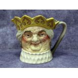 A Royal Doulton 'Old King Cole' Musical Character Jug, designed by H. Fenton, wearing a yellow