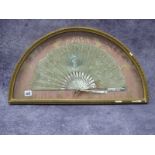 A French Late XIX Century Fan, in painted silk with mother of pearl sticks, contained in glazed