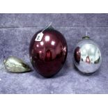 A Purple Glass Witches Ball, of pear shape with metal mounts, 26cm long; Two