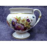 A Large Rockingham Porcelain Jug, painted with colourful sprays of summer flowers within moulded