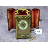 An Early XX Century Carriage Clock, the shaped rectangular brass case applied with foliate