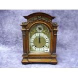A Late XIX Century German Walnut Cased Bracket Clock, by Lenzkirch, the arched brass dial with